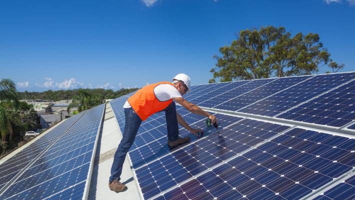Solar panels being installed on a rooftop